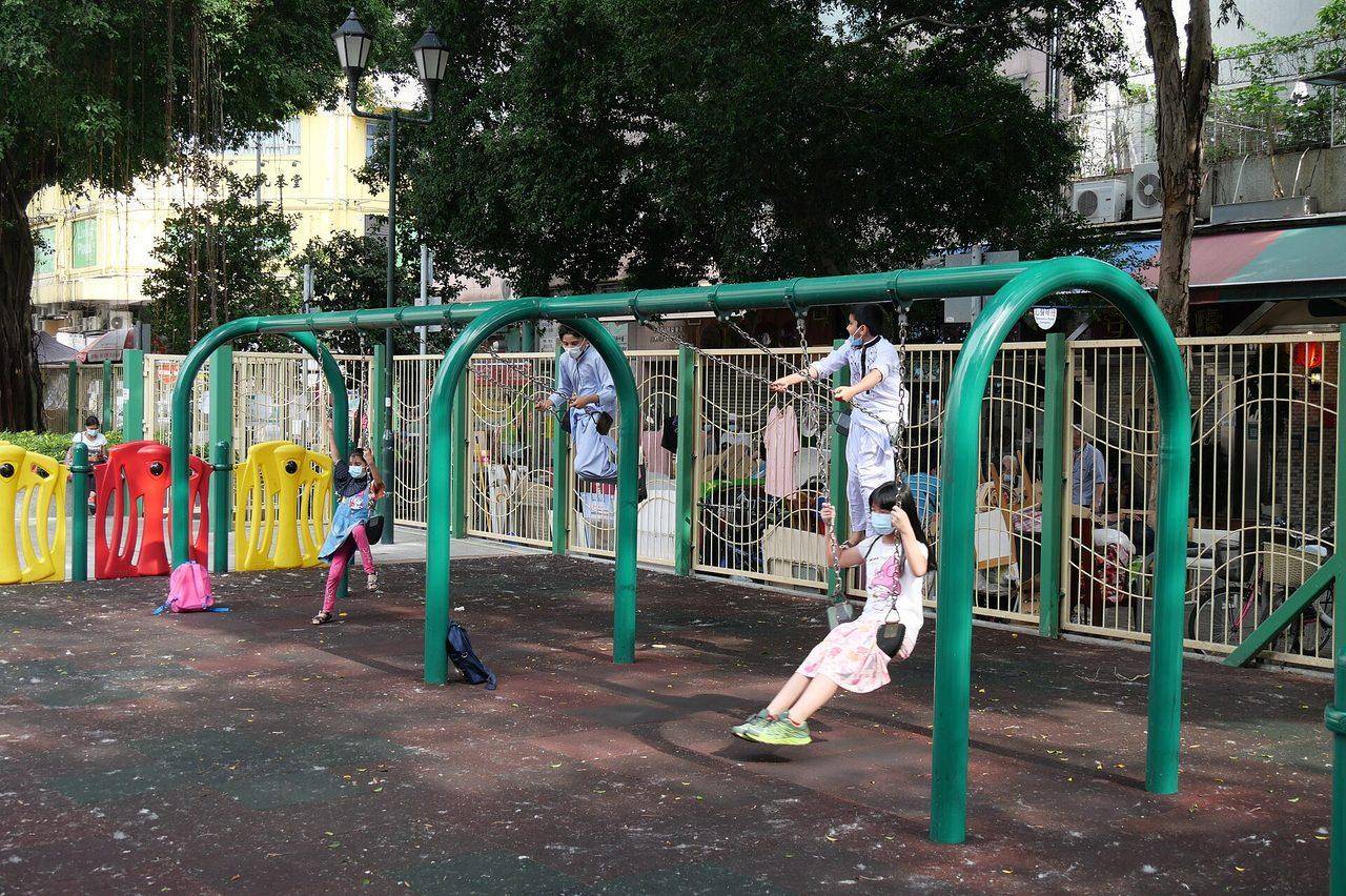 Children playing on the swings at a playground